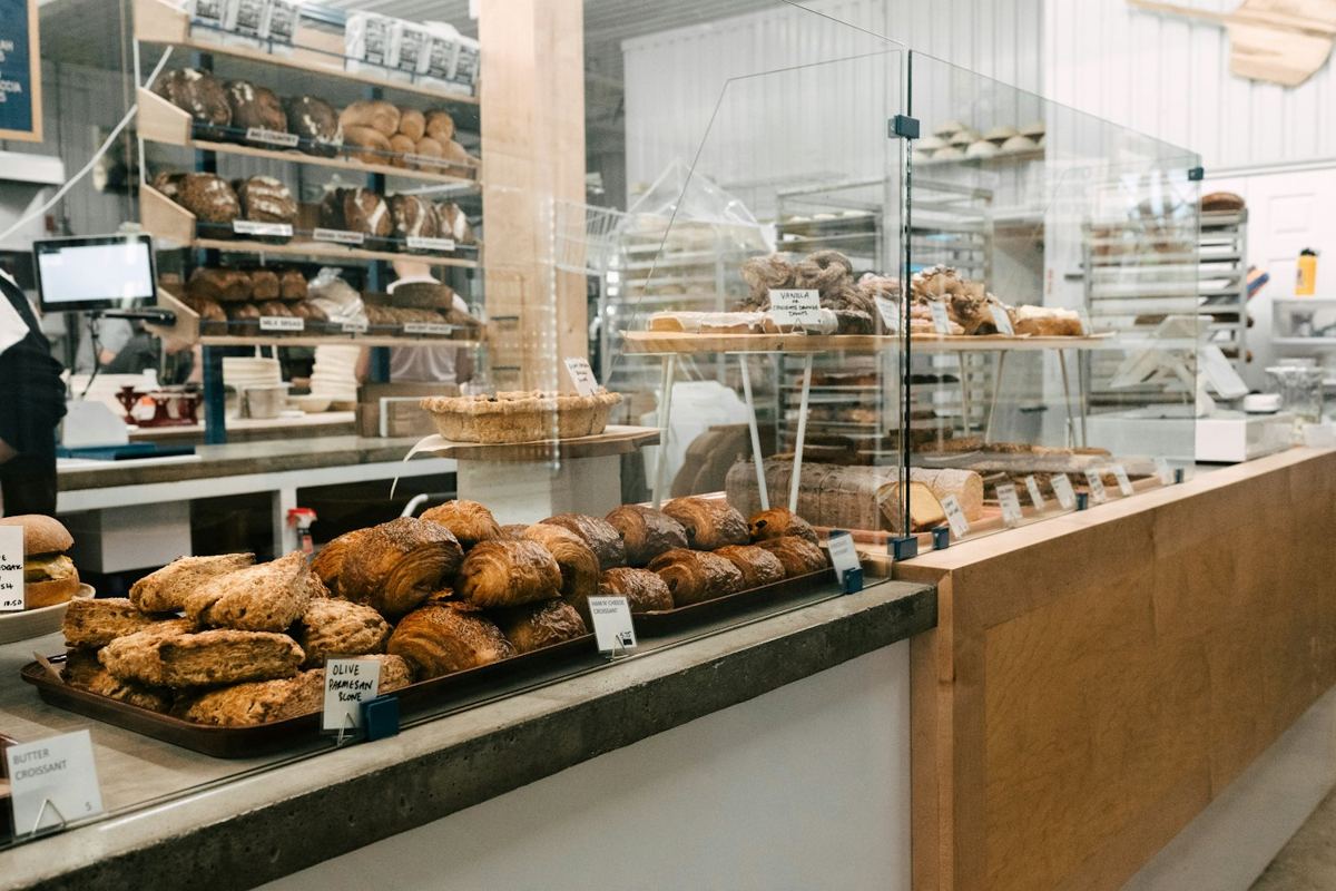 A bakery counter full of baked bread.