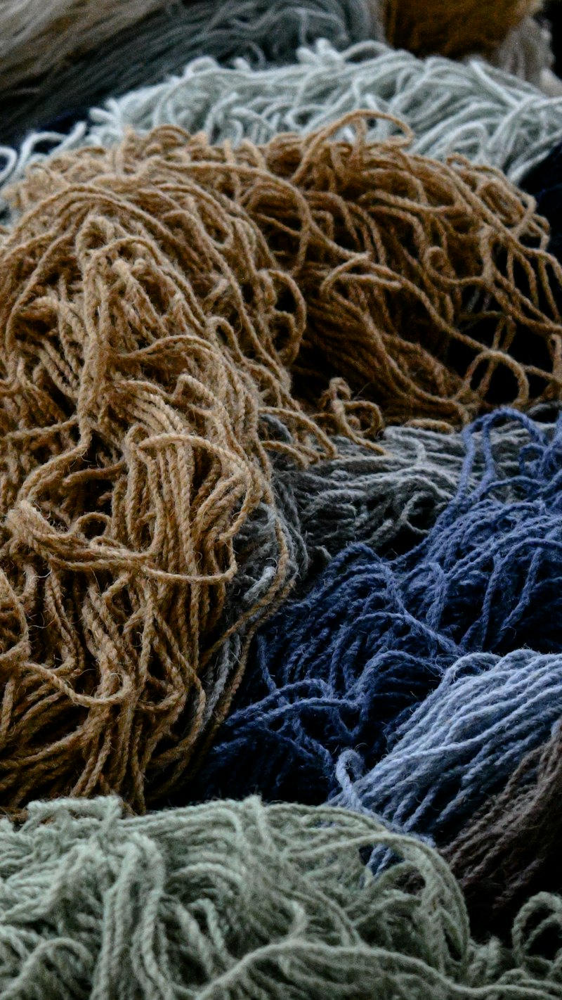 Skeins of blue and brown wool in a basket.