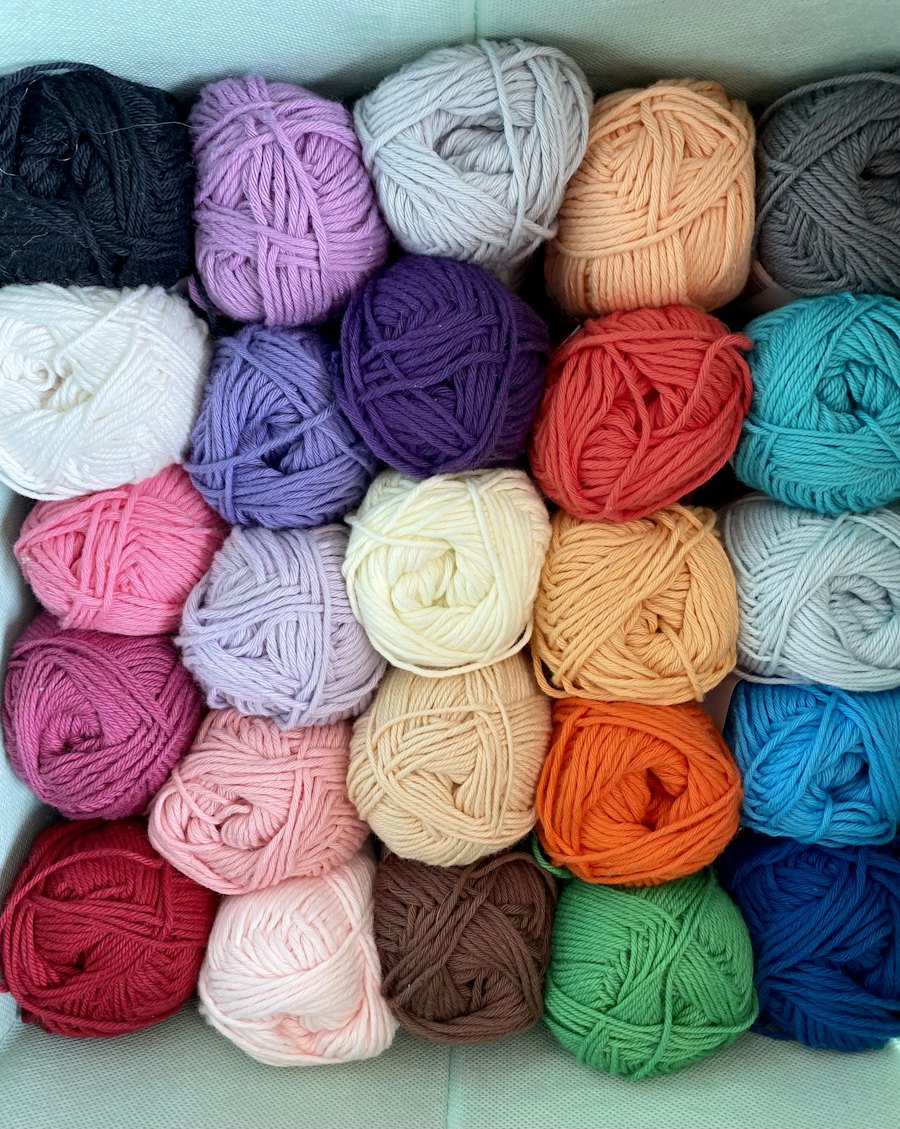 Shelves of dyed yarn skeins in many colours.