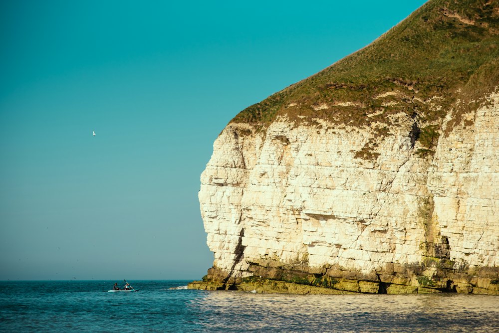 Sea and rocks beneath a coastal cliff.